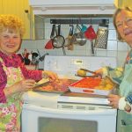 Chief chefs Sandy Warhol and Josie Thorpe, from left, do a trial run on cooking the beef and vegetables. Photo by Betty Wrenn Day