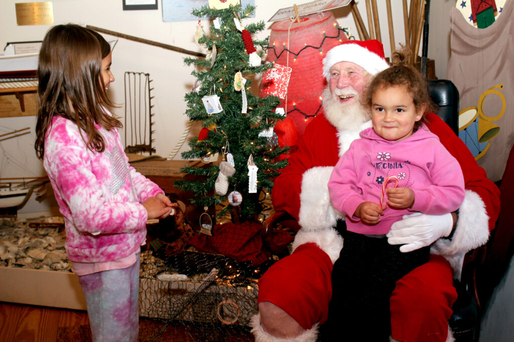 mathews santa Zoey, 8, and Nyla, 3, Banker