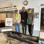 An exhibit celebrating early Mathews life and focusing on the indigenous population opened Saturday at the Mathews Museum. Among those on hand, from left, were R. Wayne Bowman of Gloucester, vice chief of the Kiskiack tribe; Zachary Yupo Thomas, president of the Native Student Club at Mary Washington University, Fredericksburg; and museum president Tom Robinson. They are standing in front of a canoe hand-hewn by historian Russell Reed of Onemo.